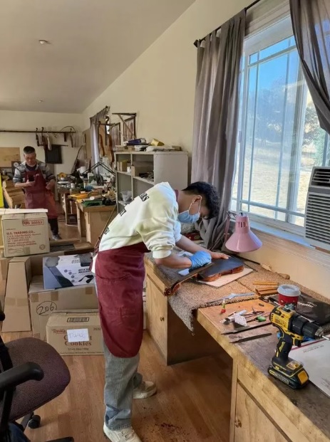 Chen Yufan working on a violin at the workshop bench